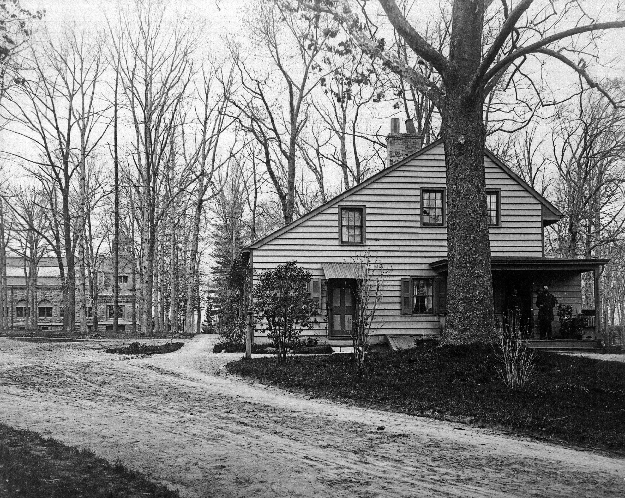 Sycamore Cottage prior to 1938.  Notice two people on porch on right